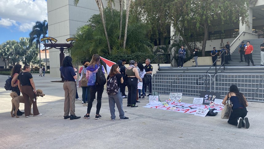 Students gather outside on a concrete entranceway at a South Florida university to protest the war in Gaza