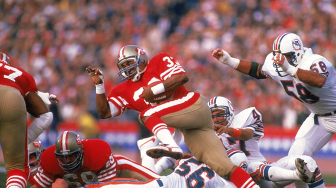 San Francisco 49ers running back rushes during Super Bowl XIX in 1985