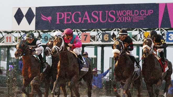 Horses racing on the track at the Pegasus World Cup