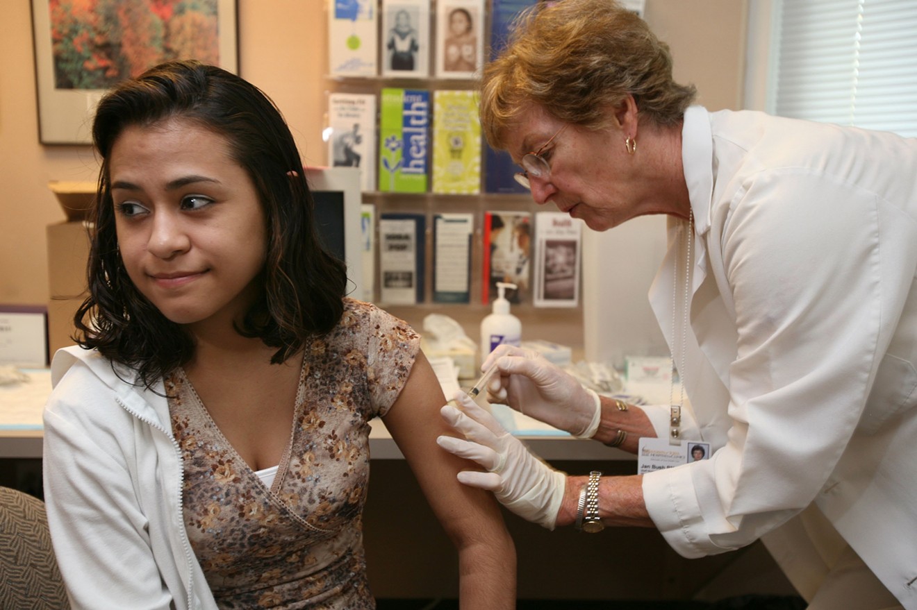 A student at the University of Iowa receives a mumps, measles and rubella (MMR) vaccination shot.