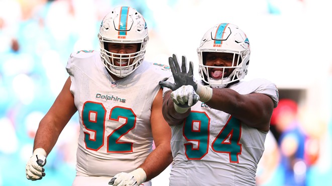 Dolphins players Sieler and Wilkins stand next to one another
