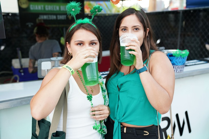 Two women drinking green beer